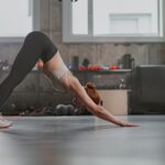 Good looking woman doing yoga pose in gym